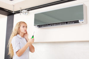 a person inspecting an AC system Belleville MI