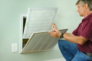 a person replacing an air filter Belleville MI