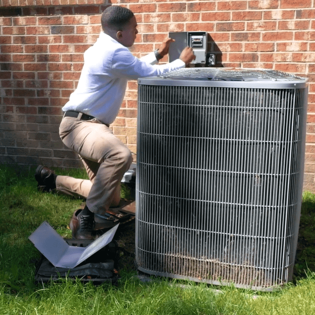 a technician inspecting an air conditioning unit Southfield MI